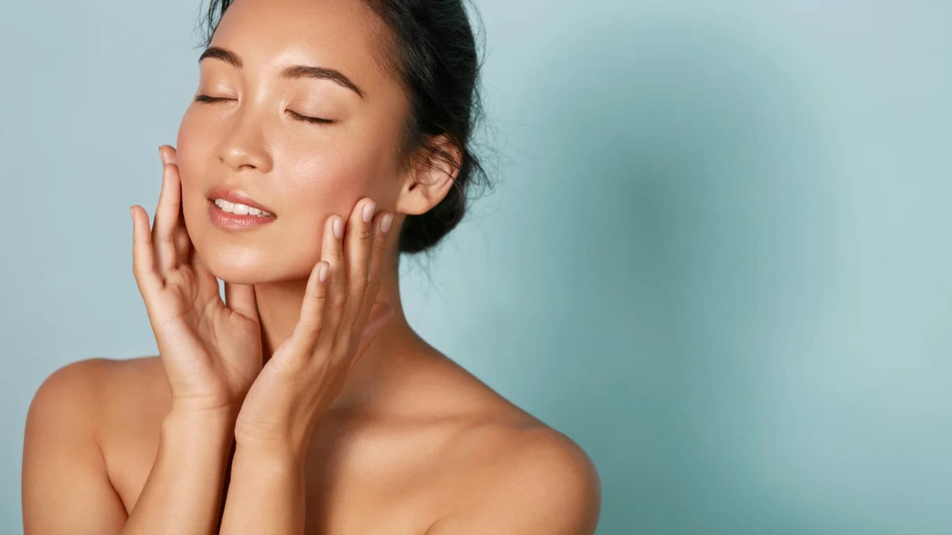 Woman relaxing in water with a flower in her hair